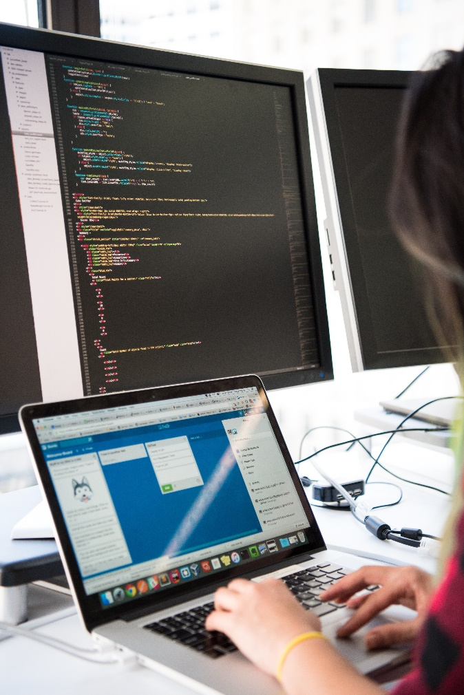 a person using a computer and a laptop